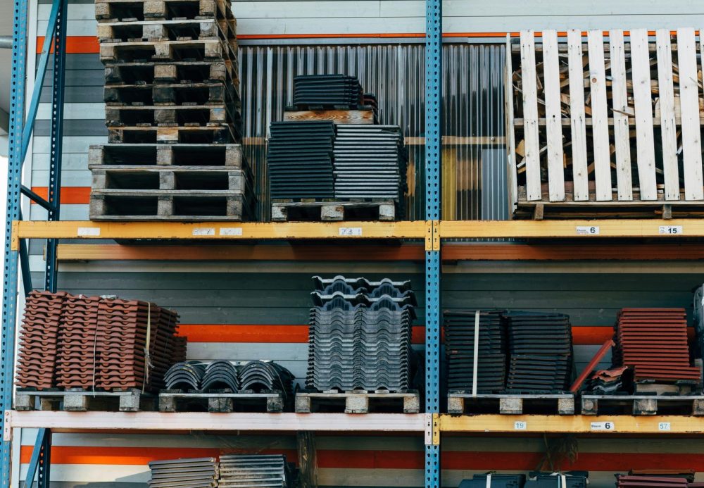 Neatly stacked building materials in a warehouse setting, showcasing construction organization.